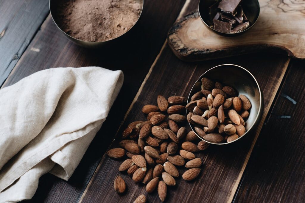 Close-Up Photo Of Almonds Beside Cloth